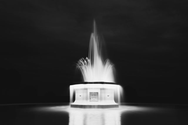 Tom Parker Fountain B&W - At night the fountain comes alive with changes of light and pattern. A rainbow of colours are shown in sequence
