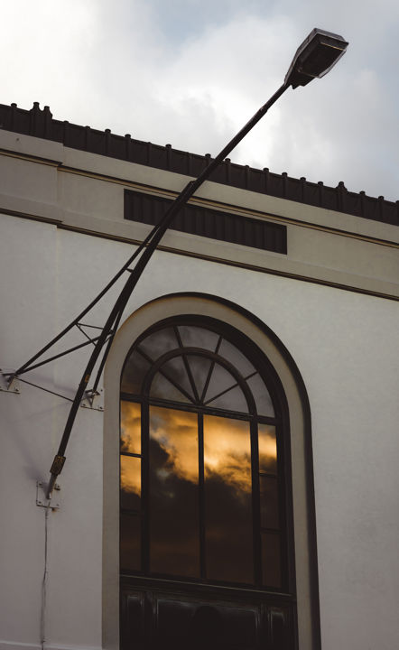 Magic In The Arched Window - Sunset reflection and street light in an arched window on a Spanish Mission style building in Napier, Hawke's Bay