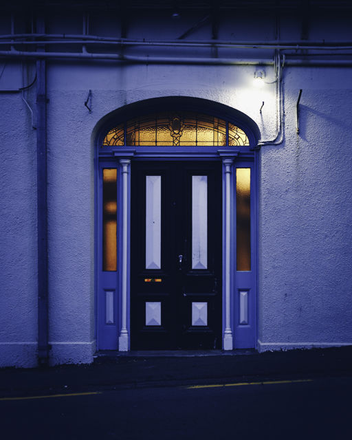 Blue Side Door - A beautiful old door framed by lead-light windows.