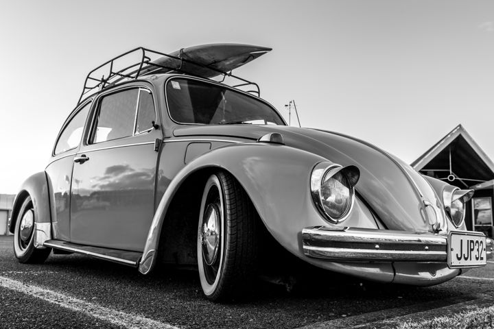 VW Beetle - A classic VW Beetle with surfboard on the roof