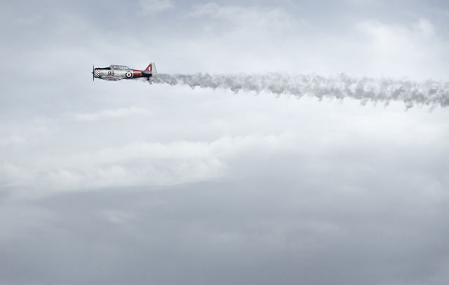 Winner On The Day - Classic Harvard aircraft with smoke trail over Napier for the Art Deco Festival 2020