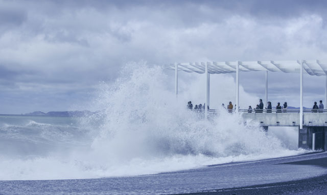 Ocean Viewing - People enjoying storm waves coming onto the Napier Ocean Viewing Platform