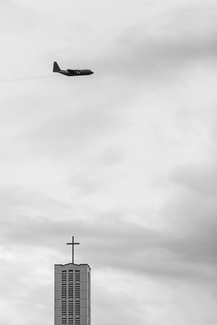 Two Wings And A Prayer - A RNZAF plane flying low over Napier's Anglican Cathedral bell tower