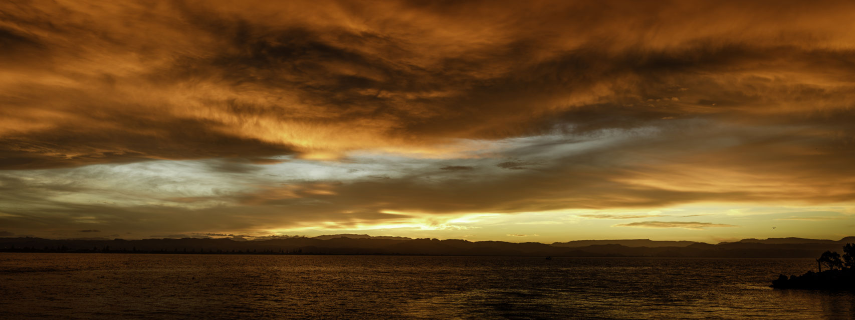Sunset Strip - Panorama sunset looking across Napier harbour to the Te Waka and Kaweka Ranges