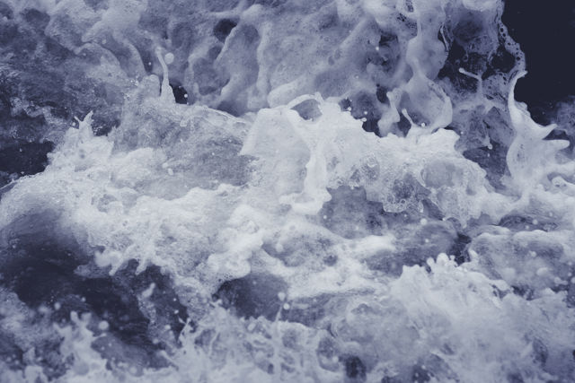 Sea Foam - Ocean wave rushing in between rocks