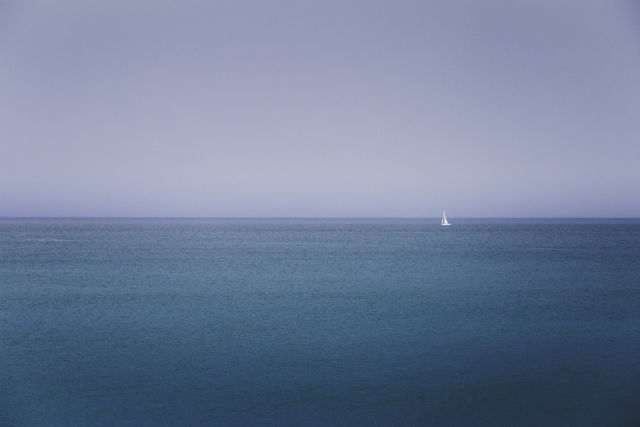 Sailing Away - A tiny yacht on a vast ocean.